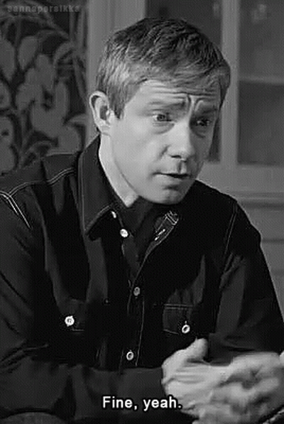 Man in Black Shirt Sitting and Talking