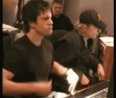 Man In Black Shirt Sitting At Desk With Keyboard GIF