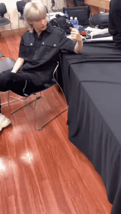 Man In Black Shirt Sitting In Chair GIF