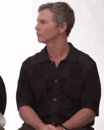 Man In Black Shirt Sitting In Chair GIF