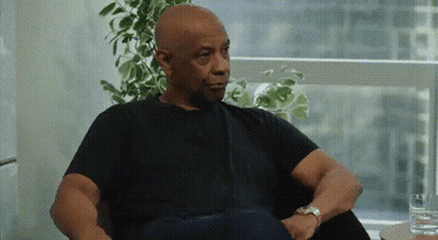 Man In Black Shirt Sitting In Chair With Glass Of Water GIF