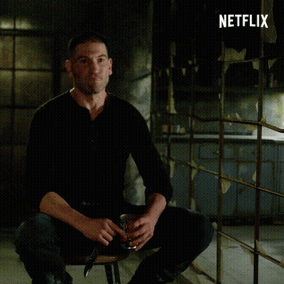Man In Black Shirt Sitting In Front Of Netflix GIF