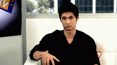 Man In Black Shirt Sitting In Front Of TV Sign GIF