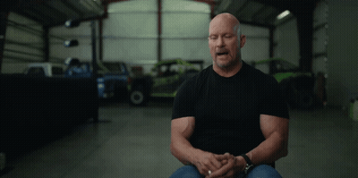 Man In Black Shirt Sitting In Garage GIF