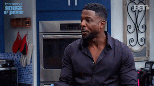 Man In Black Shirt Sitting In Kitchen With Tyler Perry's House Of Payne GIF