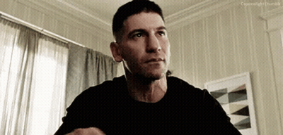 Man In Black Shirt Sitting In Living Room GIF