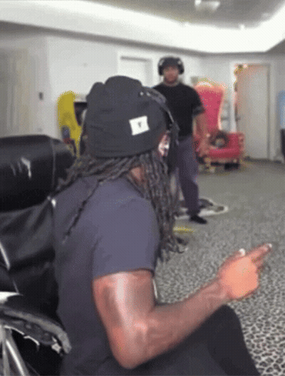 Man In Black Shirt Sitting In Red And Black Chair Justfanum GIF