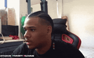 Man In Black Shirt Sitting In Red And Black Chair With Justfanum GIF