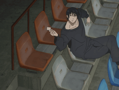 Man In Black Shirt Sitting In Row Of Seats GIF