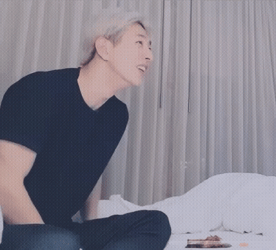Man In Black Shirt Sitting On Bed Head Down GIF