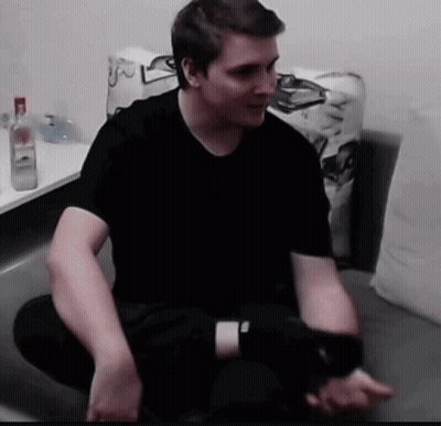 Man In Black Shirt Sitting On Couch GIF