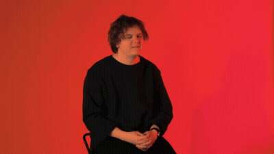 Man In Black Shirt Sitting GIF