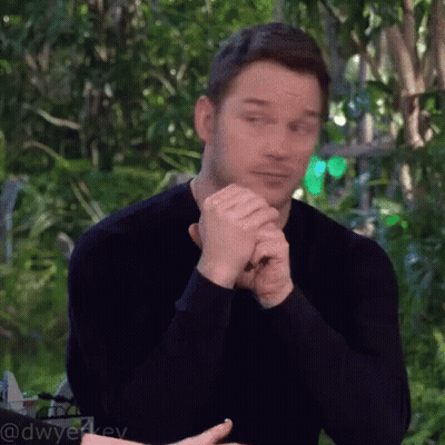 Man In Black Shirt Sitting With Folded Hands GIF