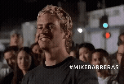 Man In Black Shirt Smiling Before Crowd GIF