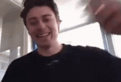 Man In Black Shirt Smiling Holding Water Glass GIF