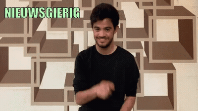 Man In Black Shirt Smiling In Front Of Nieuwsgierig Wall GIF