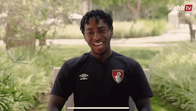 Man In Black Shirt Smiling In Park GIF