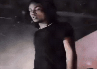 Man In Black Shirt Standing At Microphone GIF