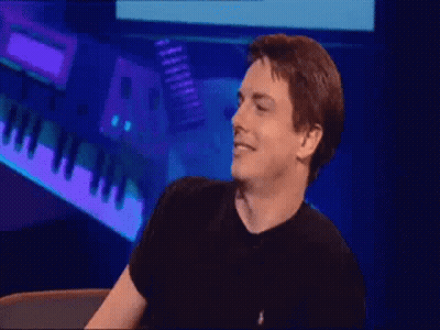 Man In Black Shirt Standing At Piano Keyboard GIF