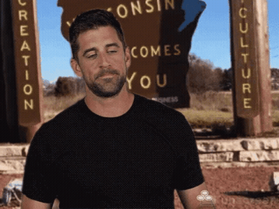 Man In Black Shirt Standing Before Creation Sign GIF