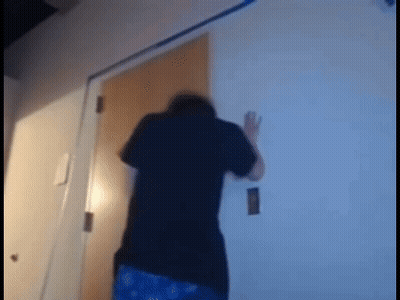 Man In Black Shirt Standing Before Door GIF