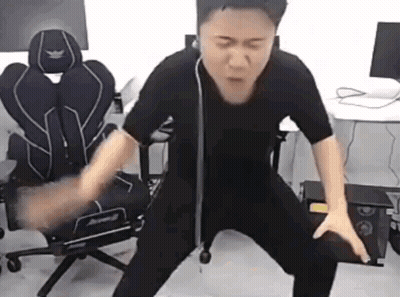 Man In Black Shirt Standing By Computer Chair GIF