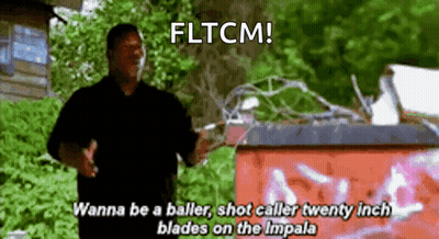 Man In Black Shirt Standing By Red Trash Can Says Fltcm GIF