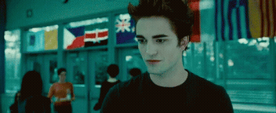 Man In Black Shirt Standing By Window With Flags GIF