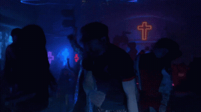 Man In Black Shirt Standing In Crowd GIF