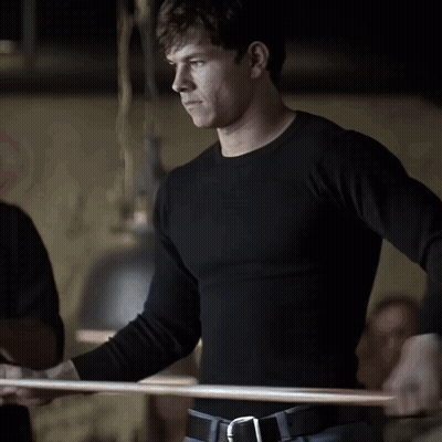Man In Black Shirt Standing In Dark Room GIF