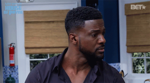 Man In Black Shirt Standing In Front Of Bet Logo GIF