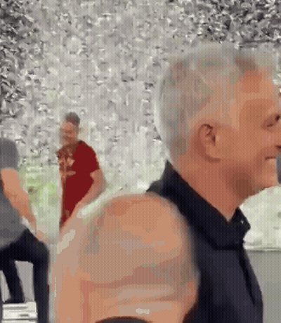 Man In Black Shirt Standing In Front Of Crowd GIF