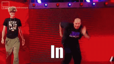 Man In Black Shirt Standing In Front Of Crowd Saying In GIF