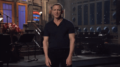 Man In Black Shirt Standing In Front Of Ladies Sign GIF