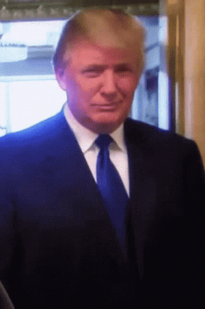 Man In Black Shirt Standing In Front Of Sign Saying Yes Is The Answer GIF