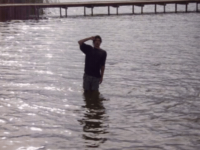 Man In Black Shirt Standing In Water GIF