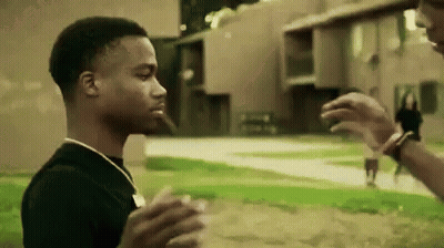 Man In Black Shirt Standing Next To Another Man In Field GIF