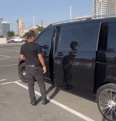 Man In Black Shirt Standing Next To Black Van GIF