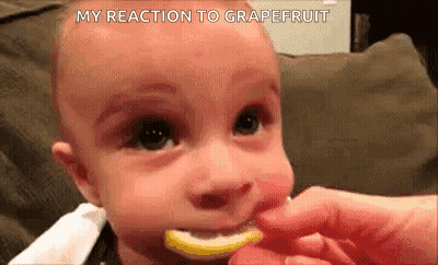 Man In Black Shirt Standing Next To Giant Lemon GIF