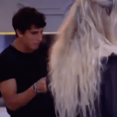 Man In Black Shirt Standing Next To Woman With Long Hair GIF