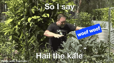 Man In Black Shirt Standing With Woof Woof Sign GIF