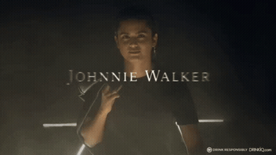 Man In Black Shirt Surrounded By Johnnie Walker Logo GIF