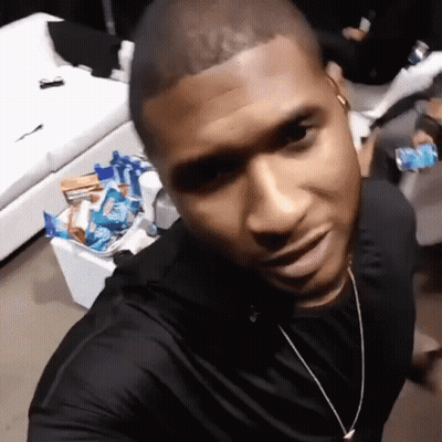 Man In Black Shirt Taking Selfie In Front Of Couch GIF