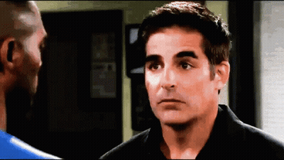 Man In Black Shirt Talking To Man In Blue Shirt GIF