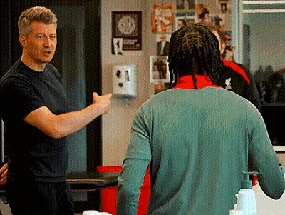 Man In Black Shirt Talking To Man In Green Sweater GIF