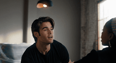 Man In Black Shirt Talking To Woman In Head Scarf GIF
