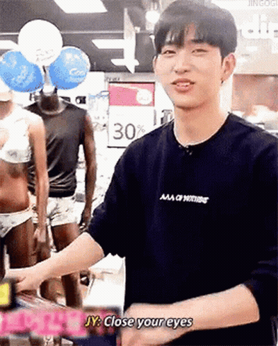 Man In Black Shirt Tells Woman In Bikini Close Your Eyes GIF