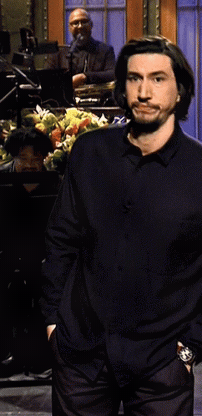 Man In Black Shirt With Hands In Pockets On Stage GIF