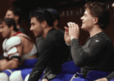 Man In Black Shirt With Letter A Next To Another Man GIF