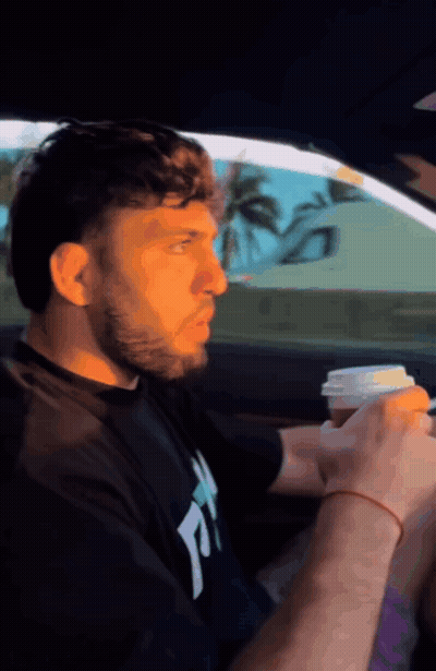 Man In Black Shirt With Letter T Drinking Coffee GIF